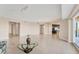 Spacious living room with tile floors flows into a modern kitchen and has sliding glass door access to the balcony at 10520 Boardwalk Loop # 503, Bradenton, FL 34202