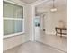Bright living room view showcases neutral paint, tile flooring, and water views through a large window at 10520 Boardwalk Loop # 503, Bradenton, FL 34202