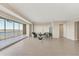 Open living room with tile floors and large sliding doors leading to a balcony with waterfront views at 10520 Boardwalk Loop # 503, Bradenton, FL 34202