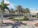 Charming shopping center featuring a fountain, lush landscaping, and various storefronts under a blue sky at 10520 Boardwalk Loop # 503, Bradenton, FL 34202