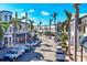 Charming street view showcasing storefronts, parked cars, and lush palm trees along the roadside at 10520 Boardwalk Loop # 503, Bradenton, FL 34202