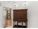 A hallway featuring a beautiful antique cabinet between the kitchen and a bedroom at 11551 30Th E Cv, Parrish, FL 34219