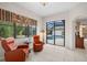 Bright living room with tile floors, comfortable seating, and sliding glass doors to the pool at 11551 30Th E Cv, Parrish, FL 34219