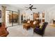 Open-concept living room with tile floors, a ceiling fan and sliding glass doors to the outdoor patio at 11551 30Th E Cv, Parrish, FL 34219