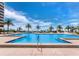 Stunning pool surrounded by swaying palm trees and lounge chairs overlooking the Gulf at 1211 Gulf Of Mexico Dr # 601, Longboat Key, FL 34228