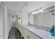 Bathroom featuring white cabinets, granite countertops, decorative lighting, and a walk-in shower at 1239 Siesta Bayside Dr # 1239C, Sarasota, FL 34242