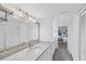 Bright bathroom featuring granite countertops, decorative lighting, tile backsplash, and neutral walls at 1239 Siesta Bayside Dr # 1239C, Sarasota, FL 34242