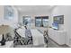 Cozy bedroom featuring neutral walls, two windows, a ceiling fan, and beach-themed decorations at 1239 Siesta Bayside Dr # 1239C, Sarasota, FL 34242