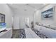 Bright bedroom featuring gray wood floors, a vaulted ceiling, beach-themed decorations, and white trim at 1239 Siesta Bayside Dr # 1239C, Sarasota, FL 34242