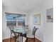 Dining area with glass table, seating for four, and sunny window view at 1239 Siesta Bayside Dr # 1239C, Sarasota, FL 34242