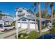 Inviting coastal-style home with multi car garage, white trim, meticulously landscaped grounds, and a paved driveway at 1239 Siesta Bayside Dr # 1239C, Sarasota, FL 34242