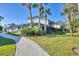 Beautifully landscaped home exterior, featuring well-maintained grounds, charming architectural details, and inviting walkways at 1239 Siesta Bayside Dr # 1239C, Sarasota, FL 34242