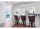 Open concept kitchen with white cabinets, stainless steel appliances, and a breakfast bar with seating at 1239 Siesta Bayside Dr # 1239C, Sarasota, FL 34242
