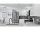 Modern kitchen with stainless steel appliances, granite countertops, and updated backsplash at 1239 Siesta Bayside Dr # 1239C, Sarasota, FL 34242