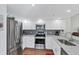 Contemporary kitchen features stainless steel appliances, sleek cabinetry, and granite countertops at 1239 Siesta Bayside Dr # 1239C, Sarasota, FL 34242
