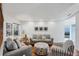 Comfortable living room featuring a seating area with sofas, side table, and access to outdoor patio at 1239 Siesta Bayside Dr # 1239C, Sarasota, FL 34242