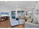 Inviting living room featuring wood floors, neutral furniture, coastal accents, and natural light at 1239 Siesta Bayside Dr # 1239C, Sarasota, FL 34242