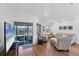 Comfortable living room with a television, light-colored furniture, and a sliding glass door at 1239 Siesta Bayside Dr # 1239C, Sarasota, FL 34242