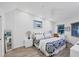 Bright main bedroom with vaulted ceiling, accent wall art and large window view at 1239 Siesta Bayside Dr # 1239C, Sarasota, FL 34242