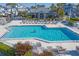 Large community pool with lounge chairs, perfect for relaxation and socializing in a beautiful outdoor setting at 1239 Siesta Bayside Dr # 1239C, Sarasota, FL 34242