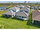 Aerial view of a home with a screened lanai and lush green lawn at 12959 Seasong Ter, Bradenton, FL 34211