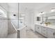 Modern bathroom featuring a glass shower, double vanity, and bright lighting at 12959 Seasong Ter, Bradenton, FL 34211
