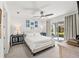 Bright bedroom featuring a ceiling fan, white walls, and sliding glass doors leading to the outside at 12959 Seasong Ter, Bradenton, FL 34211
