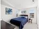 Bright bedroom featuring two large windows, wood dresser, and blue accents at 12959 Seasong Ter, Bradenton, FL 34211