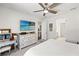 Bright bedroom with a ceiling fan, large dresser, and a view into the en-suite bathroom at 12959 Seasong Ter, Bradenton, FL 34211