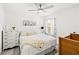 Cozy bedroom with a white dresser, patterned pillows, and floral curtains at 12959 Seasong Ter, Bradenton, FL 34211