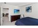 Bedroom with a TV, dark wood dresser, and open doorway into the living room at 12959 Seasong Ter, Bradenton, FL 34211