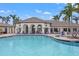 Community clubhouse pool with ample seating and lush landscaping at 12959 Seasong Ter, Bradenton, FL 34211