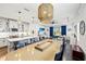 Open concept kitchen and dining room boasts modern lighting and a spacious layout for entertaining at 12959 Seasong Ter, Bradenton, FL 34211