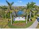 Community entrance sign for Indigo at Lakewood Ranch, surrounded by palm trees and a landscaped garden at 12959 Seasong Ter, Bradenton, FL 34211