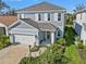 Charming two-story home with a well-manicured lawn and inviting front porch at 12959 Seasong Ter, Bradenton, FL 34211
