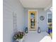 Inviting front porch with a yellow door, stylish decor, and a welcoming atmosphere at 12959 Seasong Ter, Bradenton, FL 34211