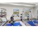 Well-equipped gym with modern equipment and views of the community pool at 12959 Seasong Ter, Bradenton, FL 34211