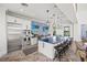 Bright kitchen with stainless appliances, large island, stool seating, and mosaic tile backsplash at 12959 Seasong Ter, Bradenton, FL 34211