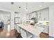 Modern kitchen with white cabinetry, stainless steel appliances, and a large island with seating at 12959 Seasong Ter, Bradenton, FL 34211