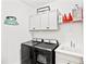 Modern laundry room equipped with front-load washer and dryer, sink, and storage cabinets at 12959 Seasong Ter, Bradenton, FL 34211