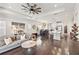 Bright living room featuring hardwood floors, a ceiling fan, and views into the open-concept kitchen at 12959 Seasong Ter, Bradenton, FL 34211