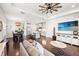 Open-concept living room and kitchen features hardwood floors, modern fixtures, and plenty of seating at 12959 Seasong Ter, Bradenton, FL 34211