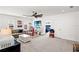 Spacious living room with a ceiling fan, ample windows, and an open floor plan at 12959 Seasong Ter, Bradenton, FL 34211
