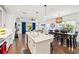 Spacious living and dining area featuring hardwood floors, modern lighting, and an open layout at 12959 Seasong Ter, Bradenton, FL 34211