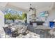 Poolside outdoor kitchen with grill, TV, and tables at 12959 Seasong Ter, Bradenton, FL 34211
