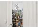 Well-organized walk-in pantry featuring ample shelving and storage space behind closed doors at 12959 Seasong Ter, Bradenton, FL 34211