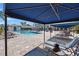 Community pool area with lounge chairs under a shaded canopy at 12959 Seasong Ter, Bradenton, FL 34211