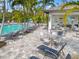 Community pool area with lounge chairs, tables, and an outdoor kitchen at 12959 Seasong Ter, Bradenton, FL 34211
