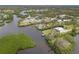 Beautiful aerial view of waterfront properties, a winding canal, and the lush vegetation of the surrounding area at 1410 San Jose Dr, Englewood, FL 34223