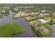 Breathtaking aerial view of a waterfront home with a sparkling pool and a private dock on the water at 1410 San Jose Dr, Englewood, FL 34223